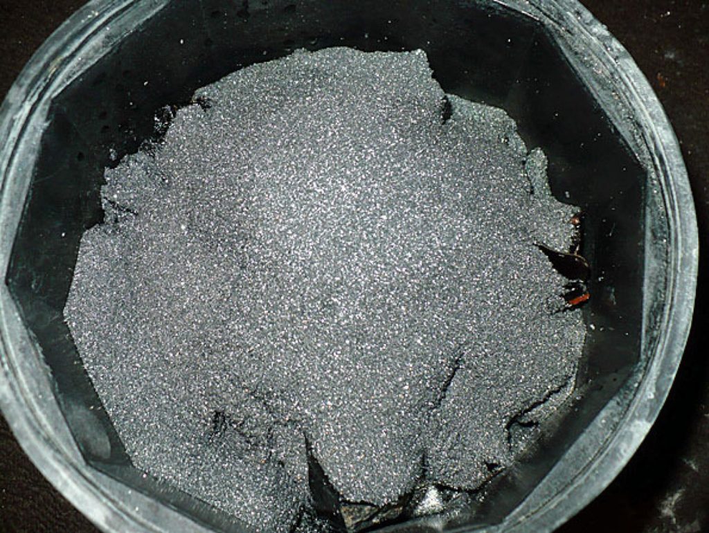 obsidian in barrel covered with grit